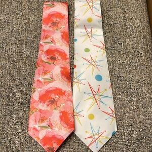 Two colorful ties never worn in plastic